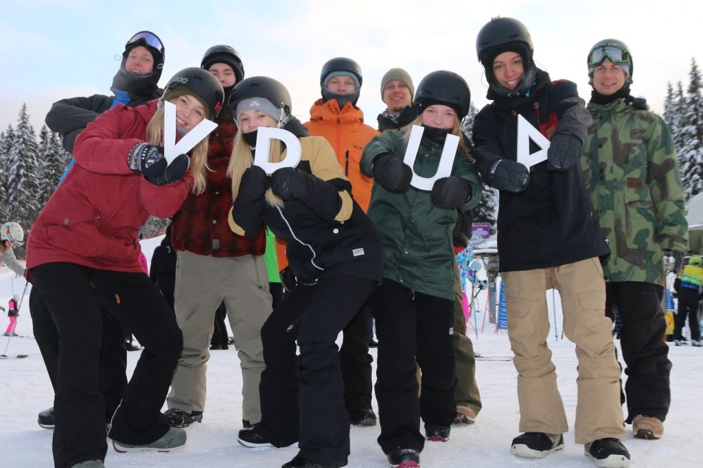 Alpine schoolstudents hold the letters V, U, R and U and smile for the camera...